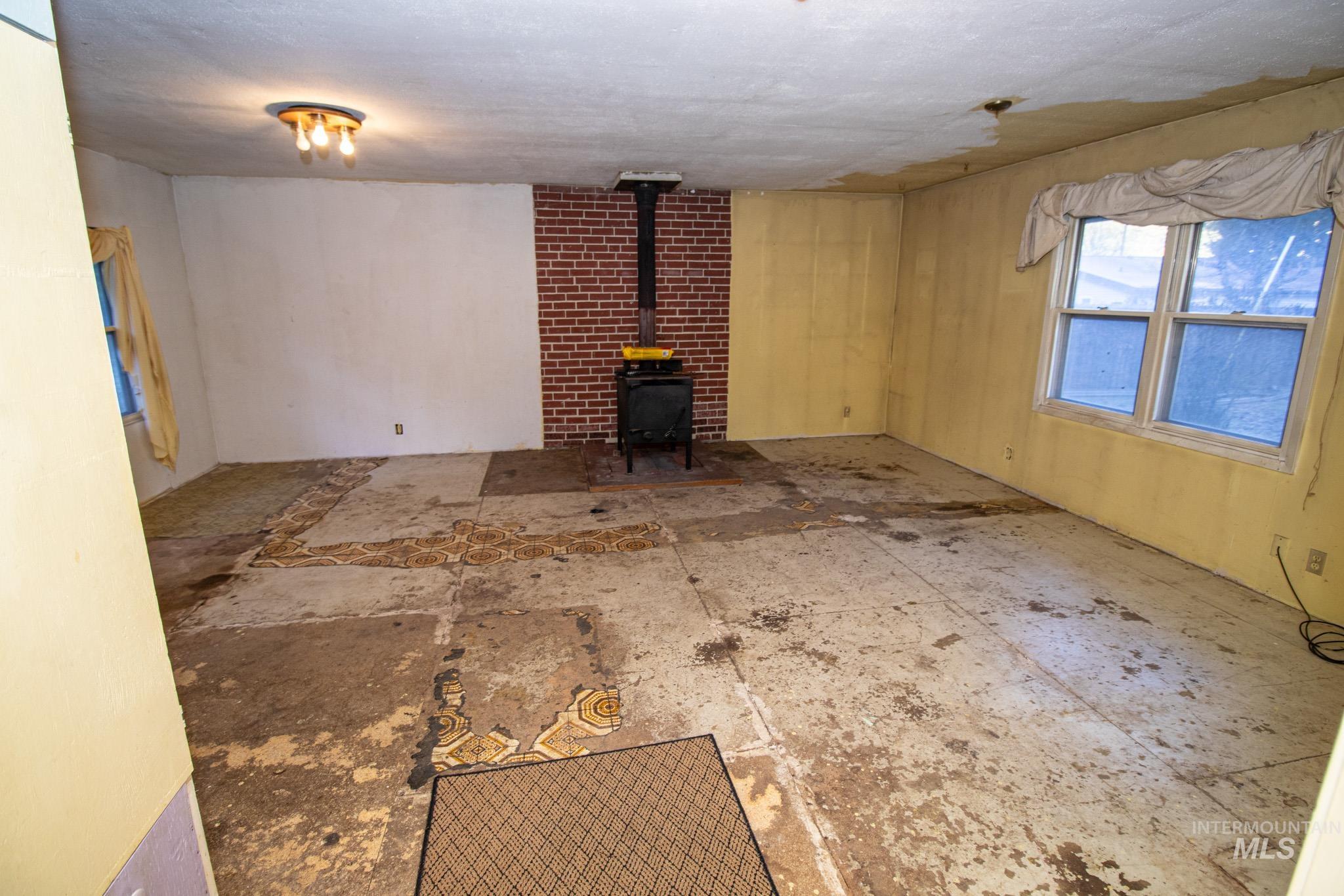 404 Harmony Heights Road Orofino, ID 83544 - Photo 19 of 35 Unfurnished living room with a wood stove