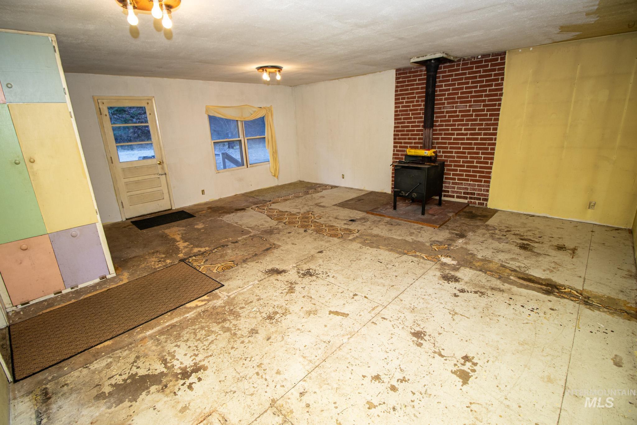 404 Harmony Heights Road Orofino, ID 83544 - Photo 20 of 35 Unfurnished living room with a wood stove