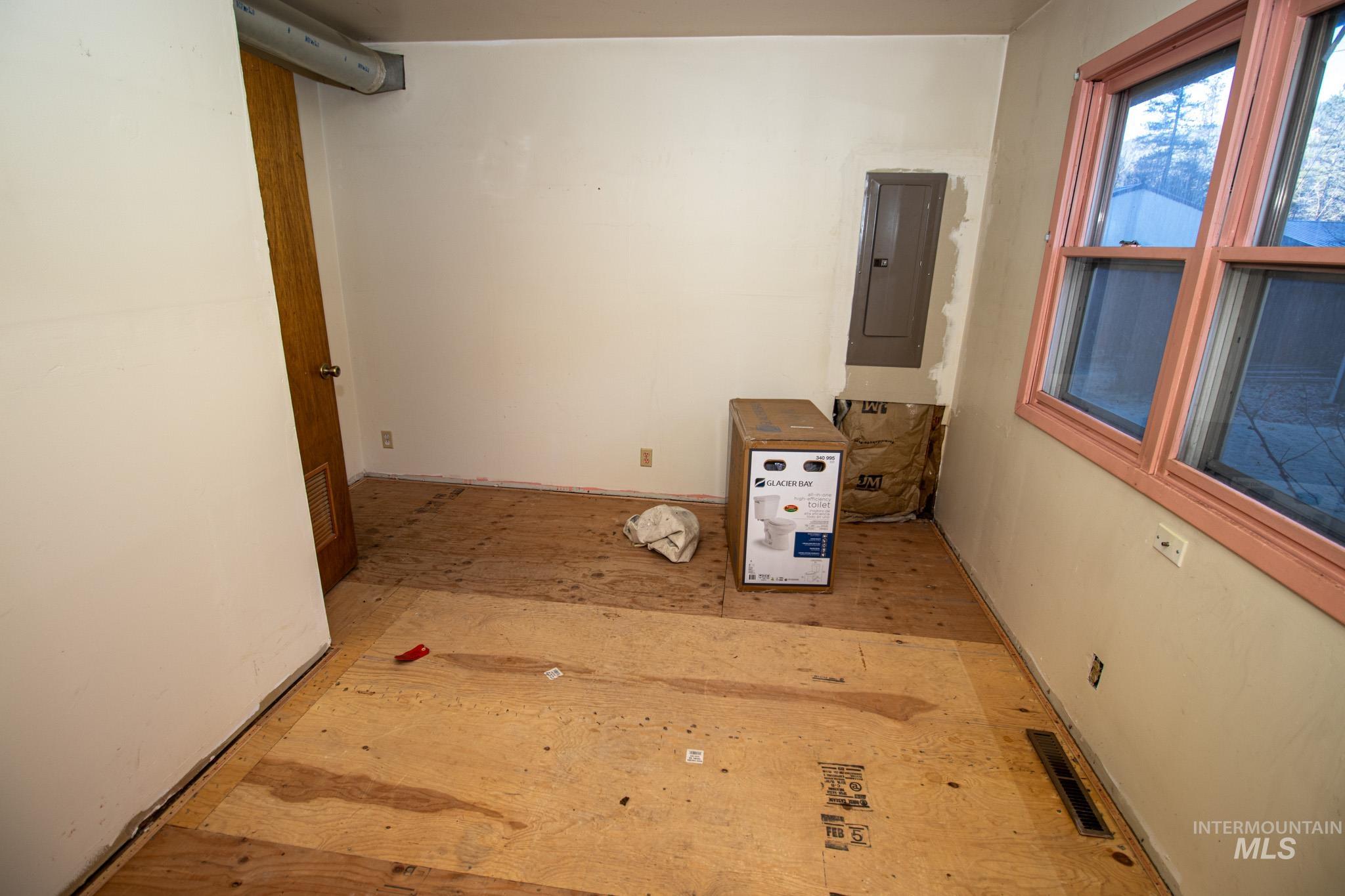 404 Harmony Heights Road Orofino, ID 83544 - Photo 22 of 35 Empty room with electric panel and wood finished floors