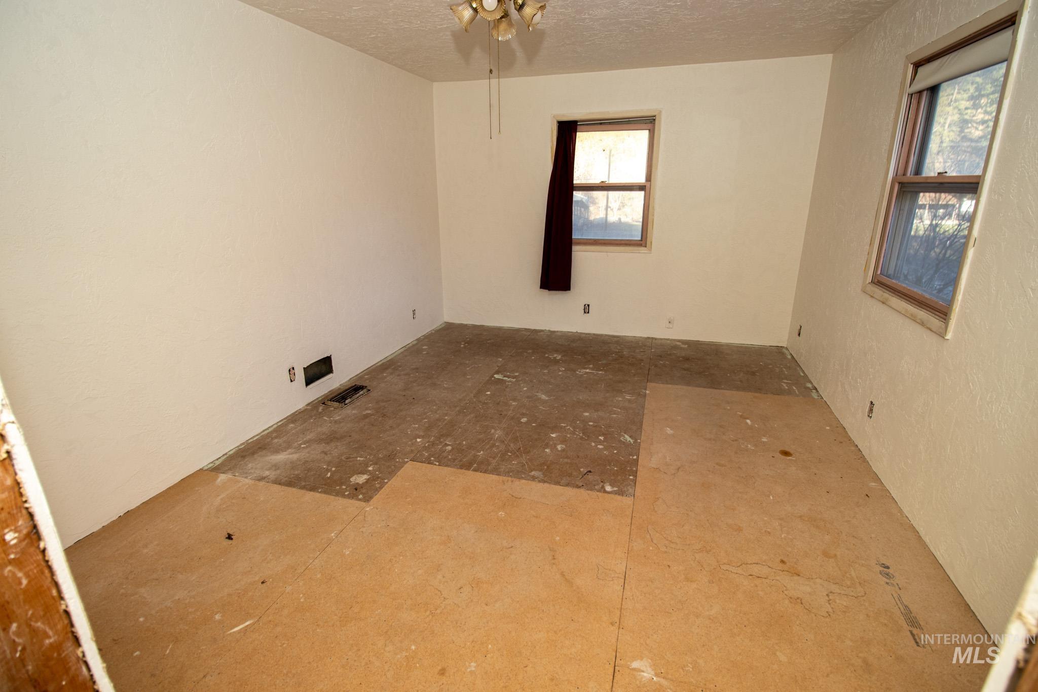 404 Harmony Heights Road Orofino, ID 83544 - Photo 28 of 35 Empty room featuring a textured ceiling, a textured wall, and a ceiling fan