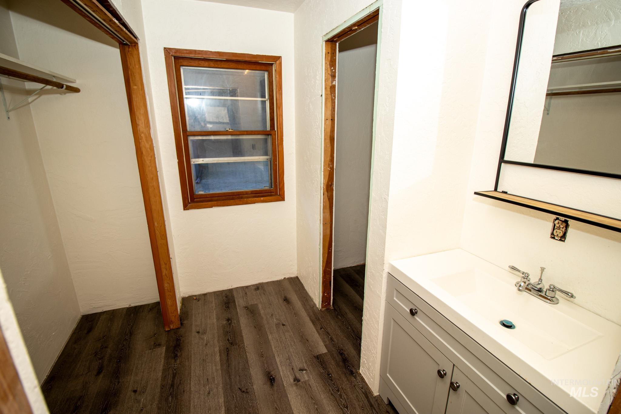 404 Harmony Heights Road Orofino, ID 83544 - Photo 30 of 35 Bathroom featuring dark wood-type flooring and vanity