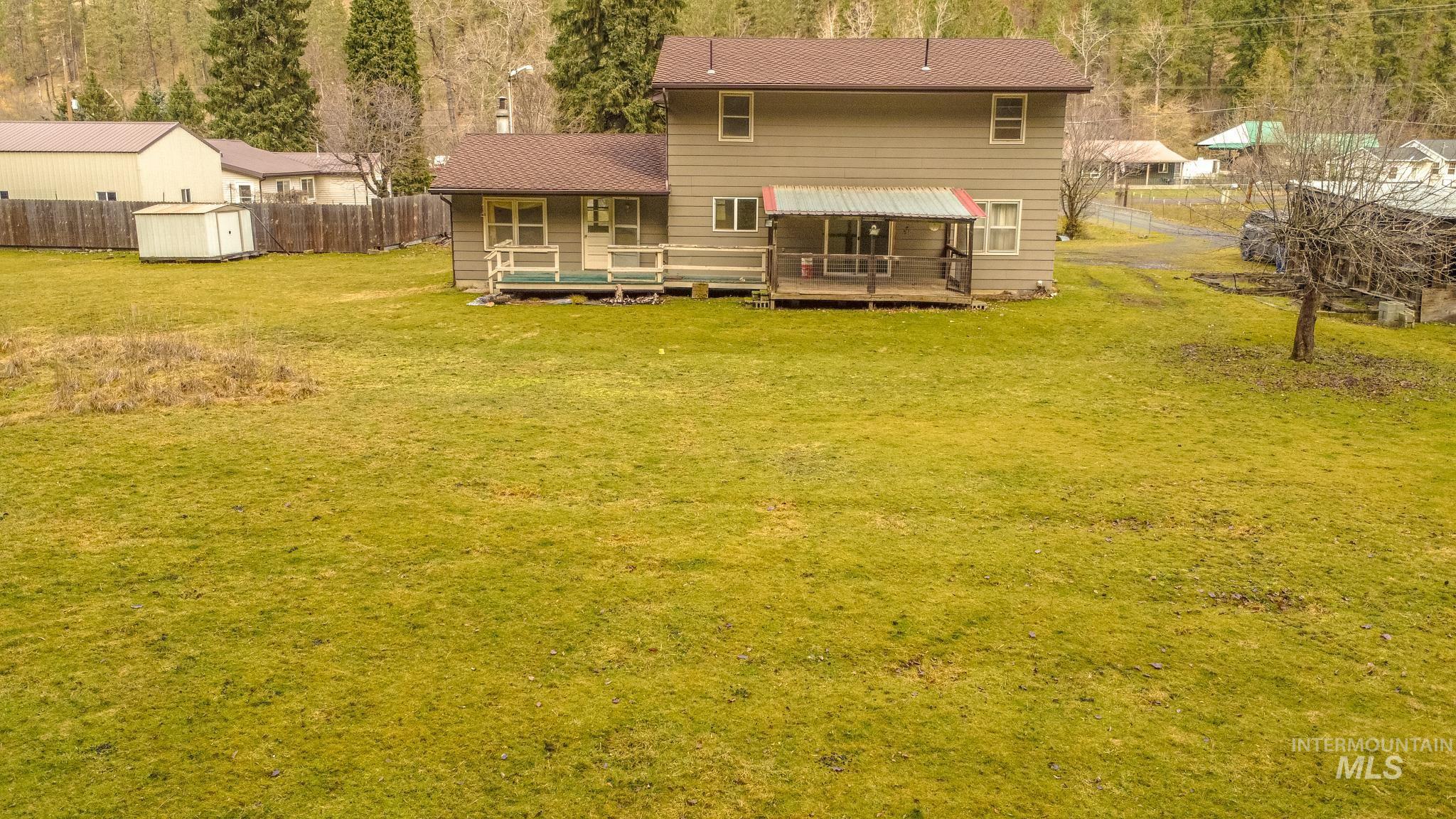 404 Harmony Heights Road Orofino, ID 83544 - Photo 10 of 35 Rear view of property featuring a wooden deck and view of scattered trees