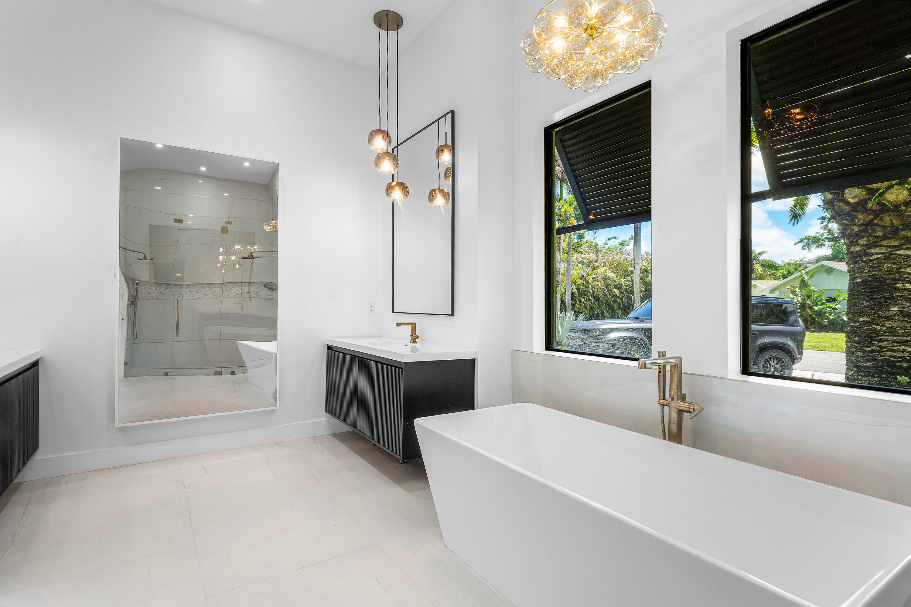 5701 Old Orange Road Jupiter, FL 33458 - Photo 24 of 46 a bathroom with a tub a sink and a large mirror