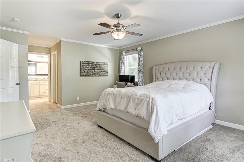 6135 Styers Ferry Road Clemmons, NC 27012 - Photo 17 of 29 Master bedroom at the end of the hallway. Walk in closet on the right.