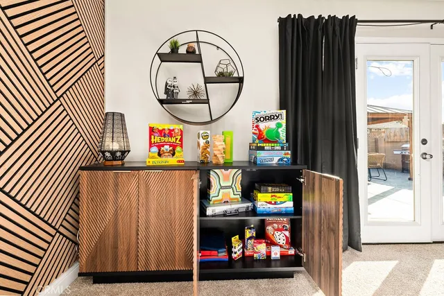 a living room with furniture and a floor to ceiling window