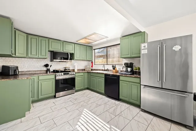 a kitchen with a refrigerator cabinets and a sink