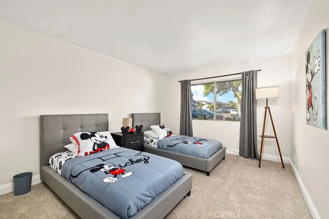 a bed room with two bed and a large window