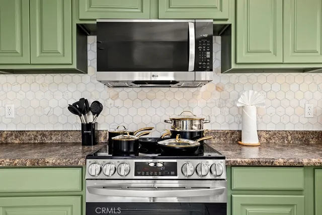 a kitchen with stove and cabinets