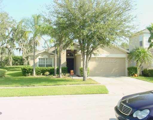 5644 Rockfield Loop Valrico, FL 33596 - Photo 1 of 1 a front view of a house with a yard and trees