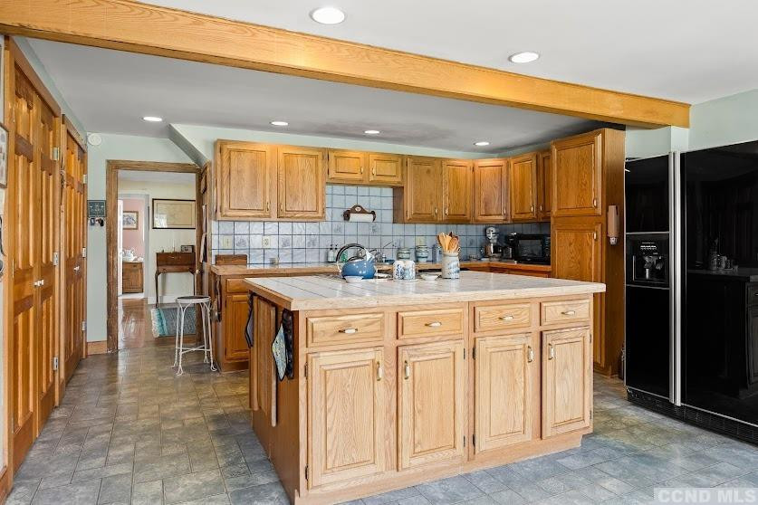 46 Broad Street Kinderhook, NY 12106 - Photo 14 of 44 a kitchen with granite countertop a sink and a refrigerator