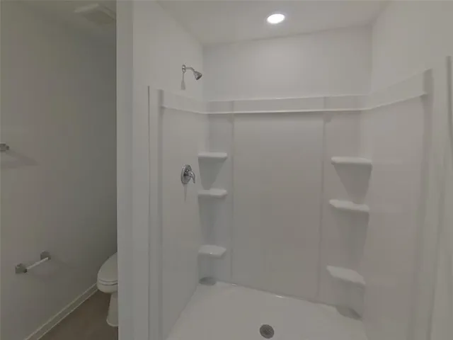 a bathroom with a shower and a toilet