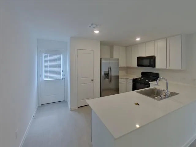 a kitchen with a refrigerator and a sink