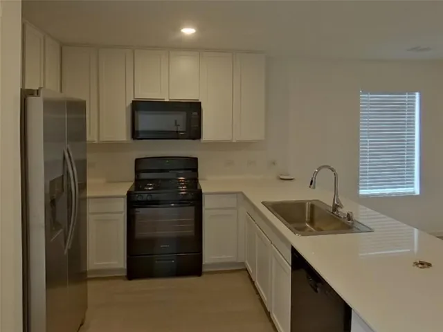 a kitchen with a sink and a refrigerator