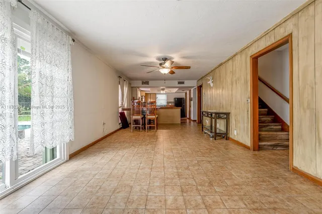 a view of a livingroom with furniture and a ceiling fan