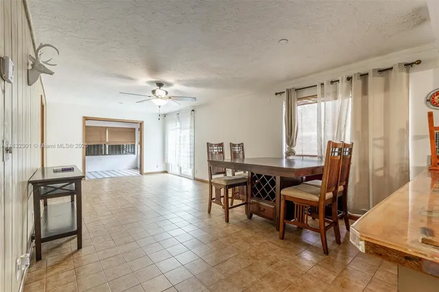 a view of a livingroom with furniture and a window