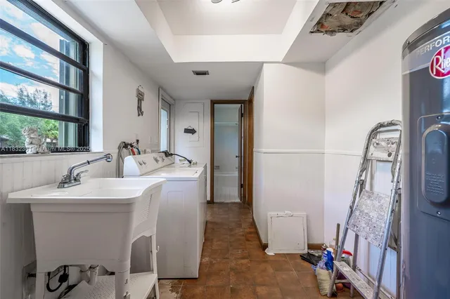 a bathroom with a sink and mirror with window
