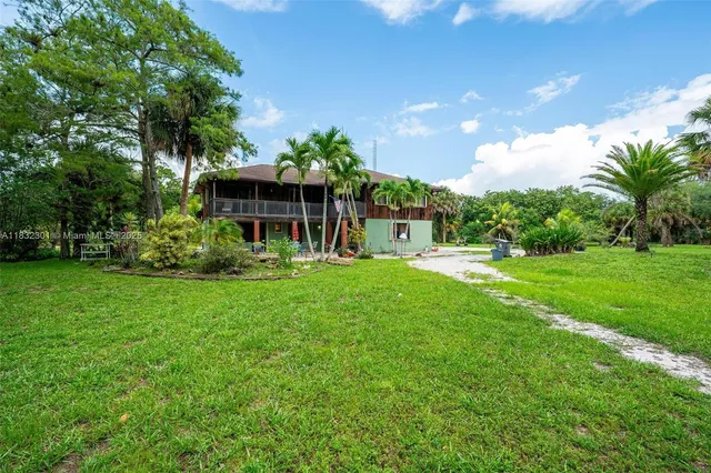 a view of house with backyard