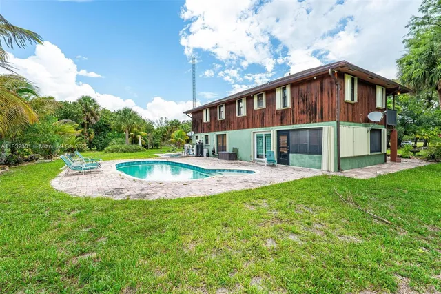 a view of a house with a yard patio and a garden