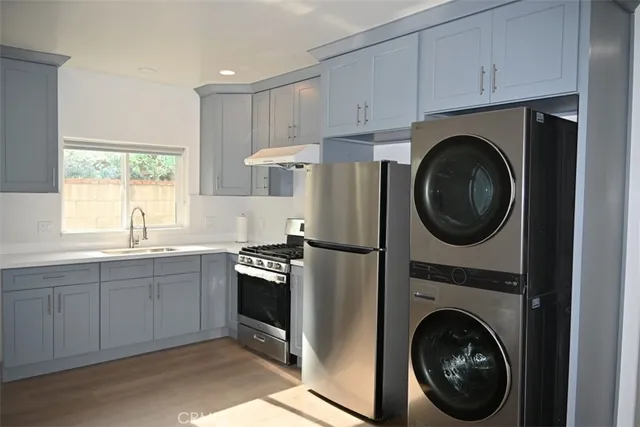 a kitchen with cabinets washer and dryer
