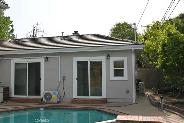 a view of a house with a yard and sitting area