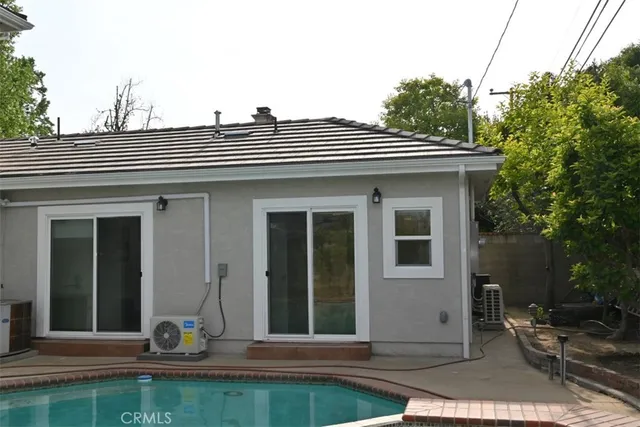 a view of a house with a yard and sitting area