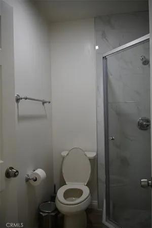 a bathroom with a toilet and a shower