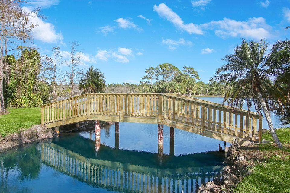 19900 Mack Dairy Road Jupiter, FL 33478 - Photo 6 of 11 a view of a balcony with floor to ceiling window and wooden fence