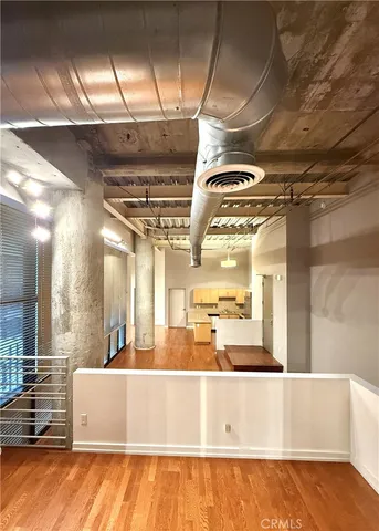 a view of kitchen with stainless steel appliances granite countertop a refrigerator and a wooden cabinets