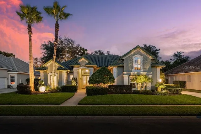 a front view of a house with a garden and yard