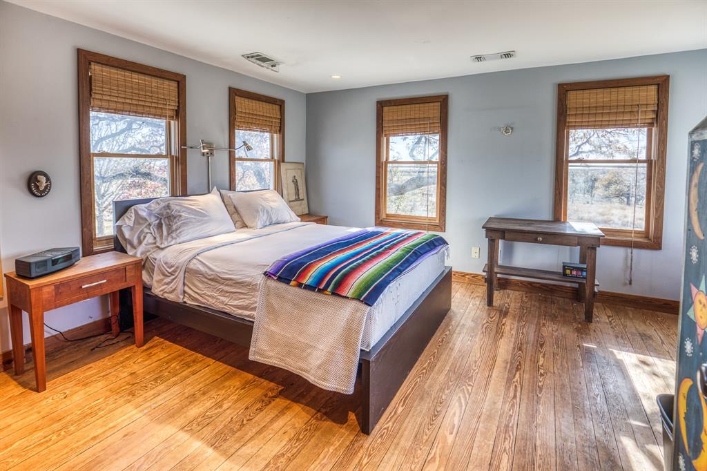 2969 County Lane Talpa, TX 76882 - Photo 16 of 40 a bed room with a bed and a chair