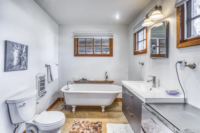 a bathroom with a toilet sink and mirror
