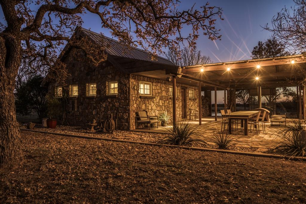 2969 County Lane Talpa, TX 76882 - Photo 21 of 40 a view of a backyard with table and chairs a fire pit and a large tree