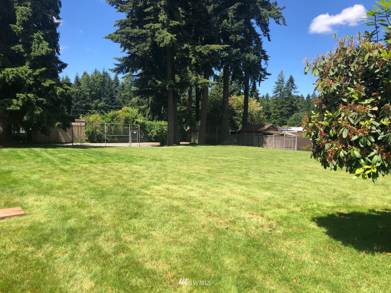 3408 206th Place Southeast Bothell, WA 98012 - Photo 25 of 26 a white house with a big yard and large trees