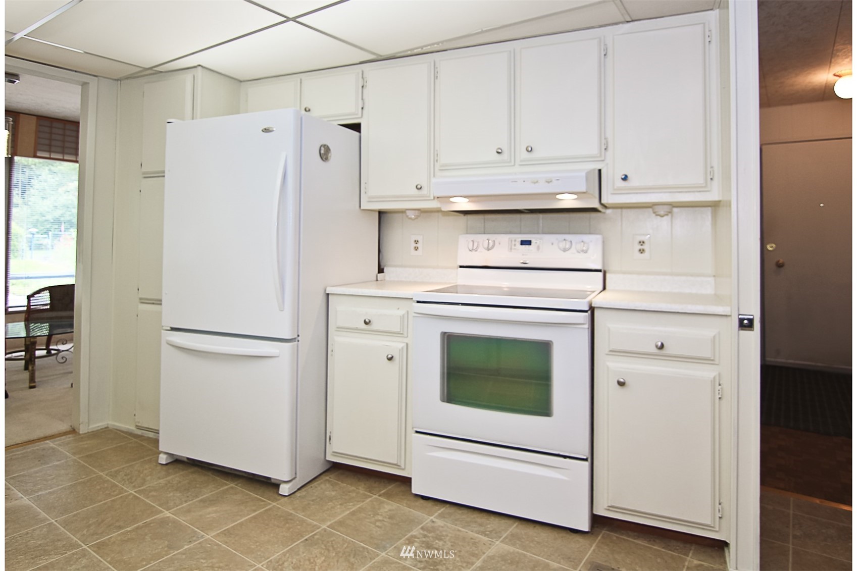 3408 206th Place Southeast Bothell, WA 98012 - Photo 6 of 26 a white refrigerator freezer and a stove sitting inside of a kitchen