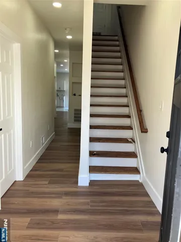 a view of entryway and hall with wooden floor