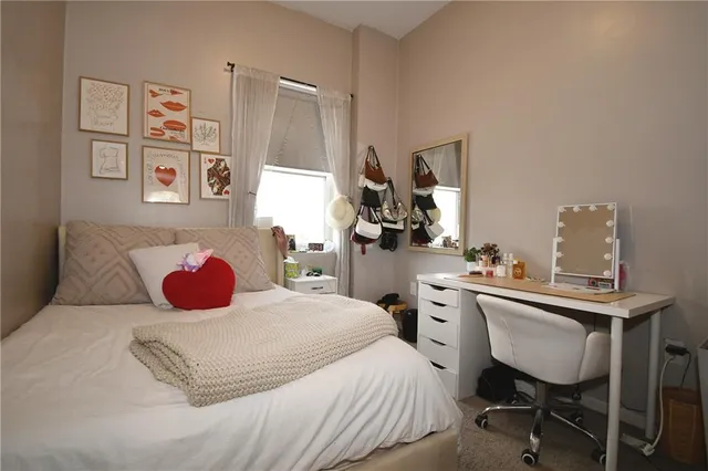 a bedroom with a bed and a dresser