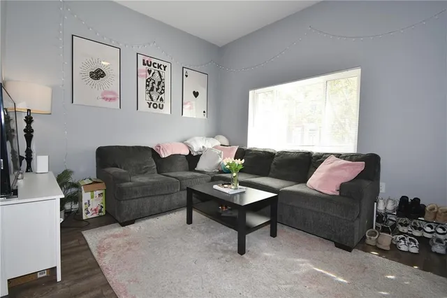 a living room with furniture and a large window