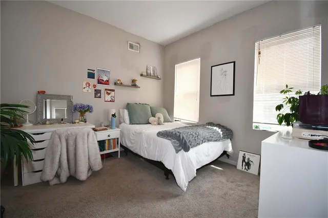 a bedroom with bed and a window