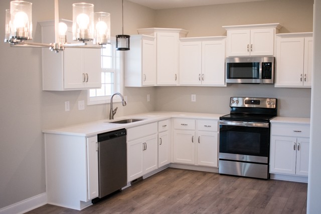 112 Cherry Fields Clarksville, TN 37042 - Photo 4 of 19 a kitchen with stainless steel appliances granite countertop a stove and a white cabinets