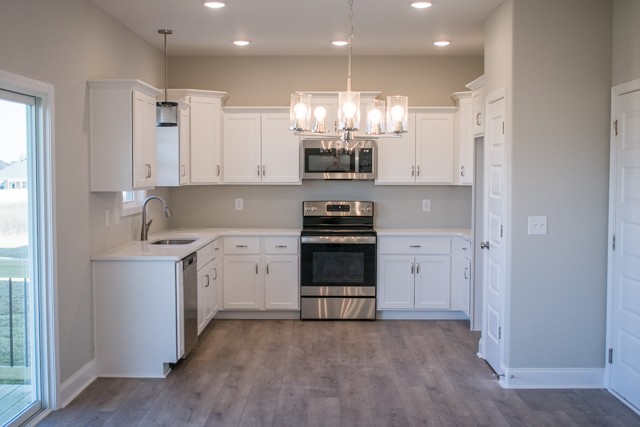 112 Cherry Fields Clarksville, TN 37042 - Photo 5 of 19 a kitchen with kitchen island granite countertop a sink cabinets and stainless steel appliances