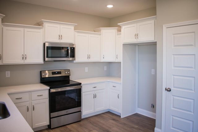 112 Cherry Fields Clarksville, TN 37042 - Photo 6 of 19 a kitchen with cabinets stainless steel appliances and wooden floor
