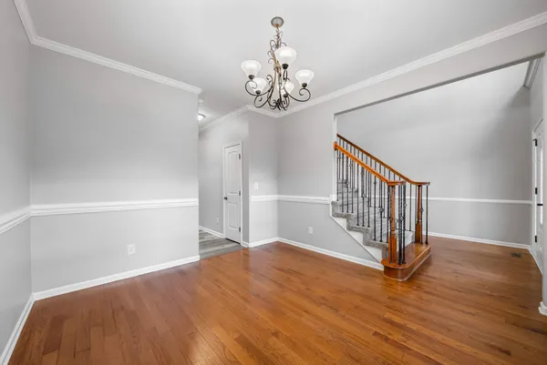 a view of an empty room with a window and a ceiling fan