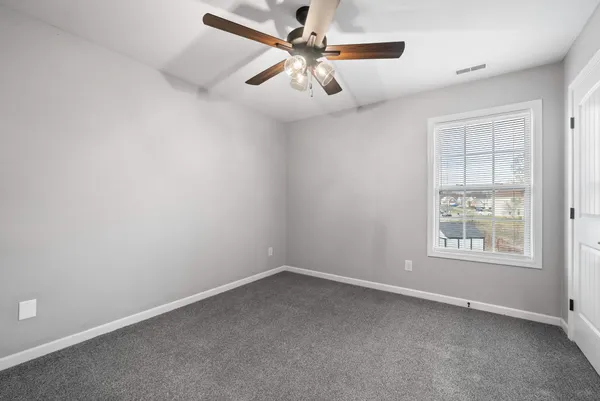 a view of an empty room with a fireplace