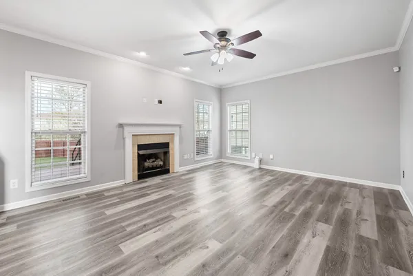 a kitchen with stainless steel appliances kitchen island granite countertop a refrigerator a stove a sink dishwasher and a microwave with wooden floor