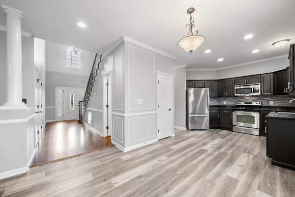 a kitchen with granite countertop stainless steel appliances and refrigerator