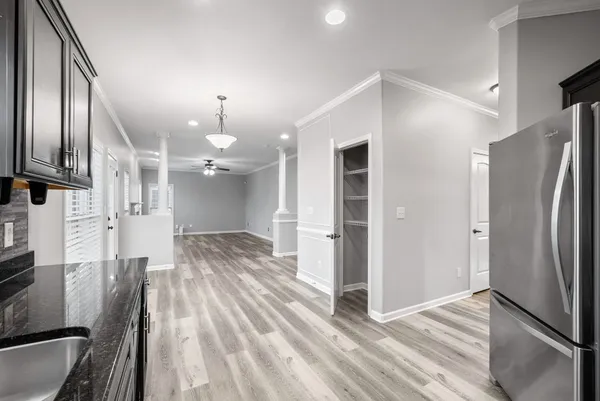 a view of an empty room with wooden floor