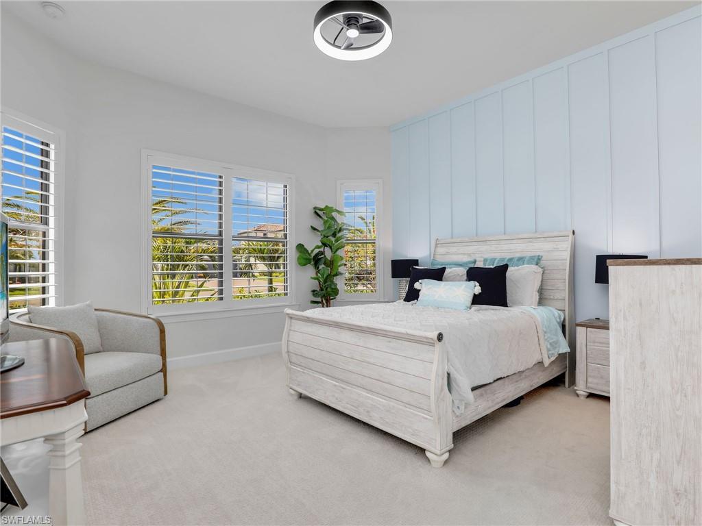18412 Ridgeline Drive Estero, FL 33928 - Photo 32 of 50 a bed sitting in a spacious bedroom next to a window
