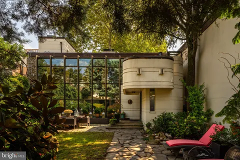 a view of a patio with table and chairs and potted plants