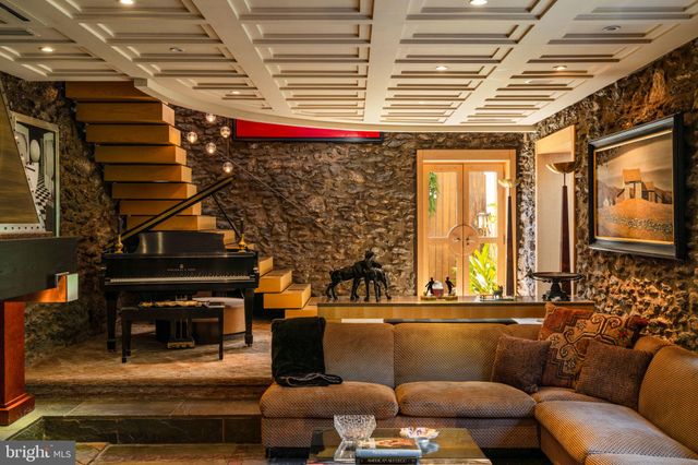 a bedroom with bed or couch and a flat screen tv