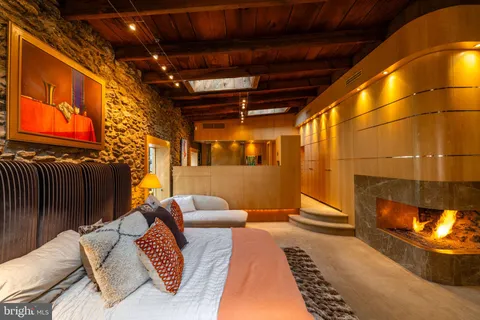 a bedroom with a bed next to a window with the outer view